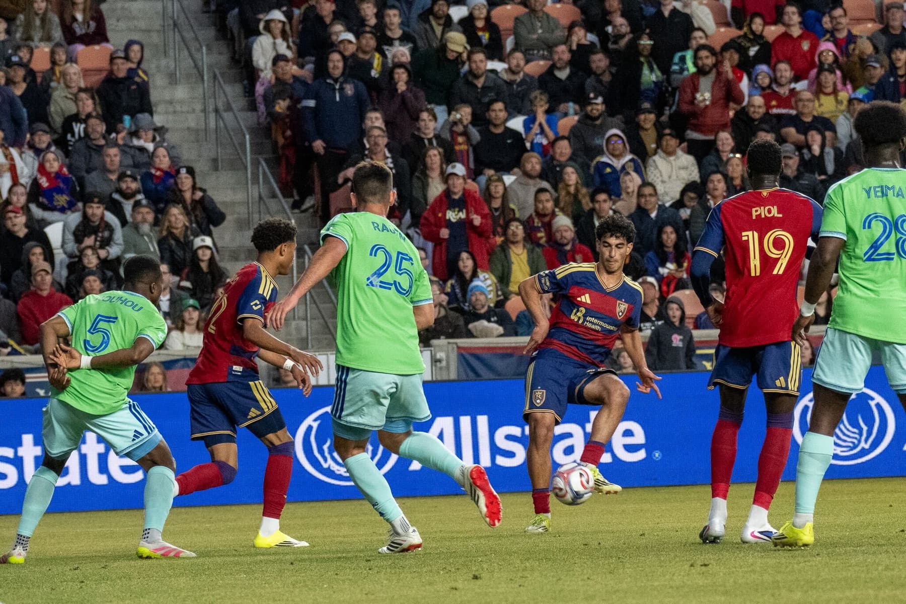 Real Salt Lake player Aiden Hezarkhani passes the ball to Zavier Gozo in a match against Seattle Sounders.